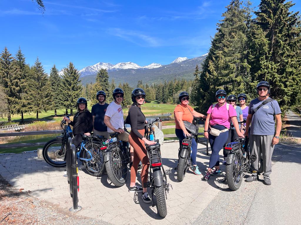 a group of people standing next to a bicycle