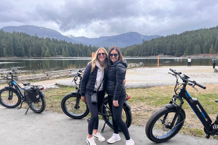 a person standing next to a parked motorcycle posing for the camera