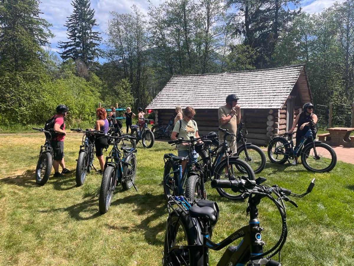 a group of people standing next to a bicycle