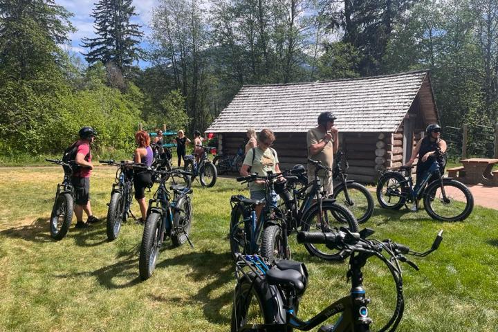 a group of people standing next to a bicycle