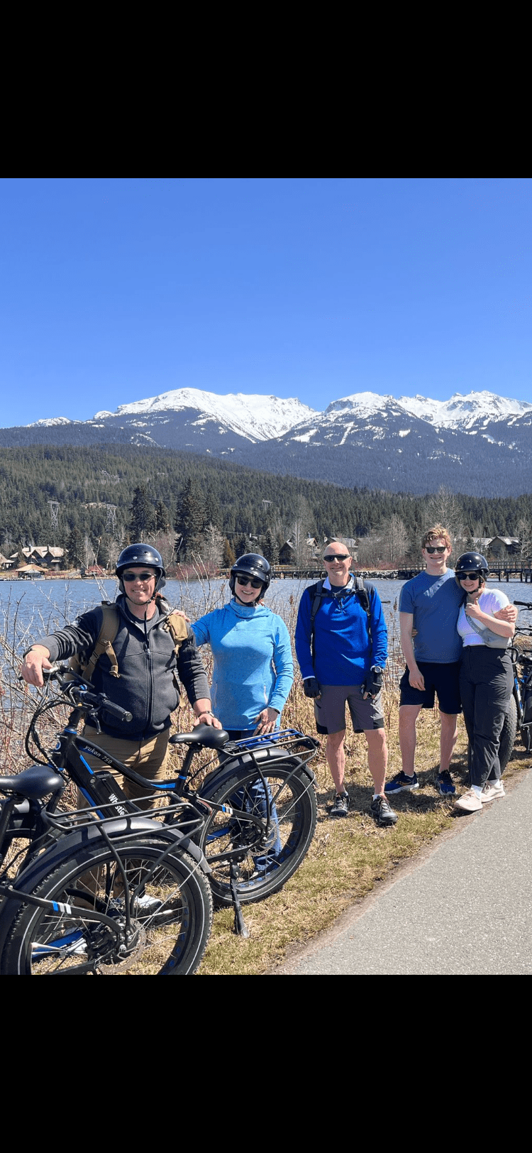a group of people standing around a motorcycle