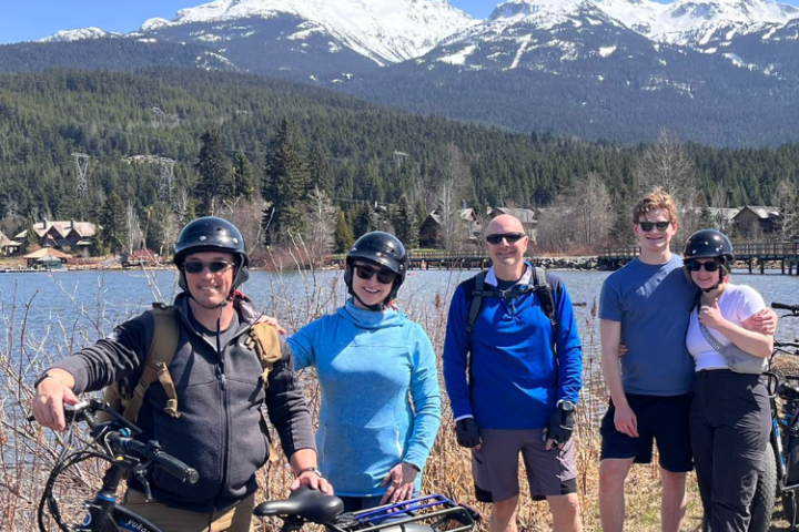 a group of people standing around a motorcycle