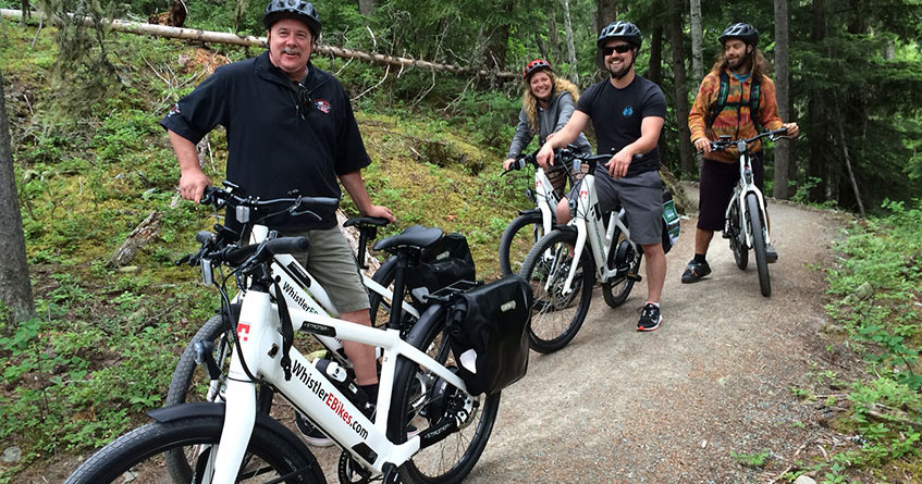 group of people riding bikes on trail
