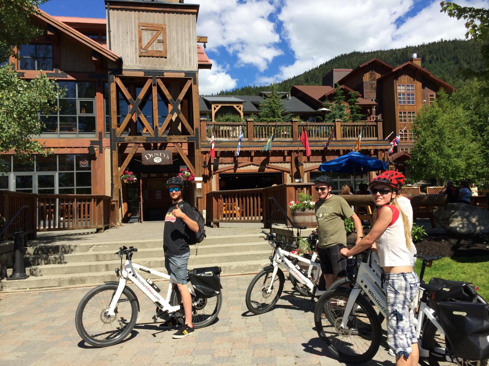 people with bike in front of building