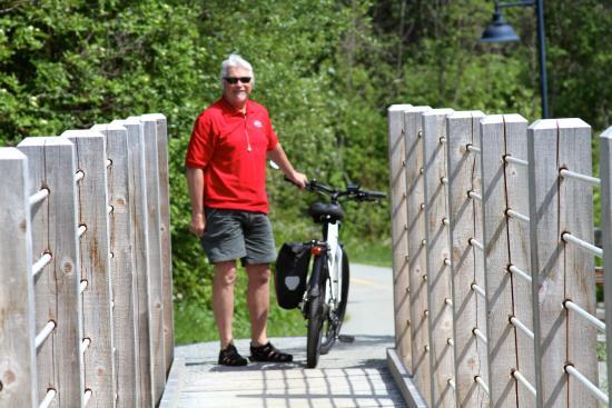 man holding bike on trail