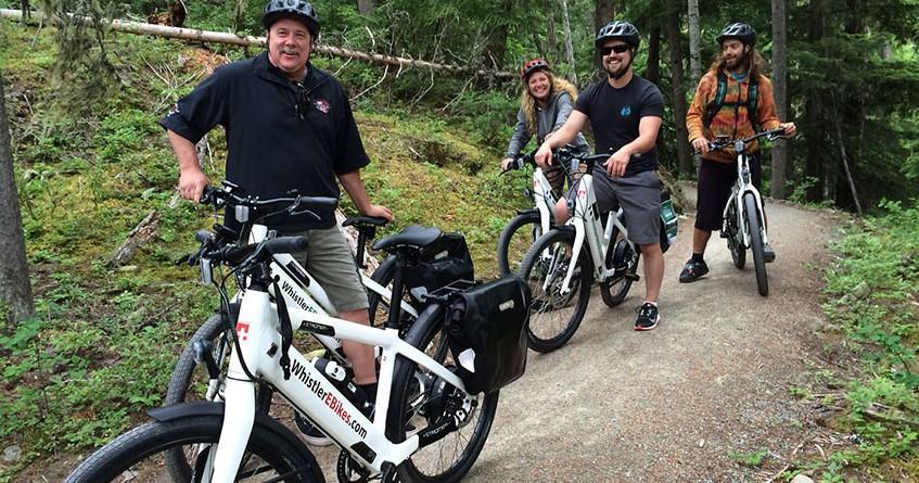 group of people riding bikes on trail