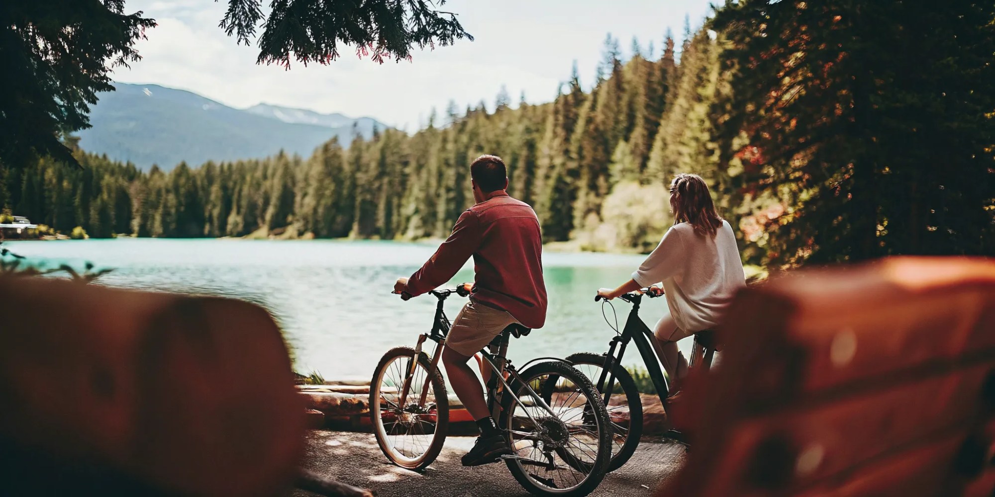Cyclists on electric bikes beside Green Lake in Whistler