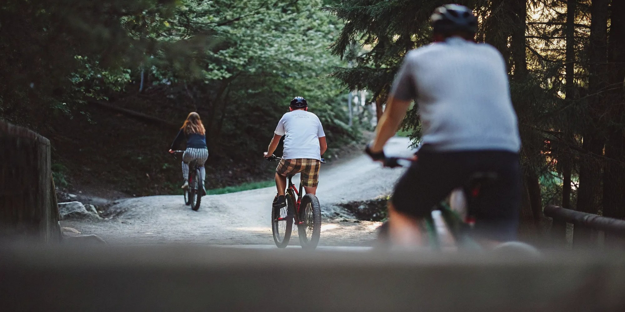 Fat tire eBikes beside a turquoise Whistler lake and cedar forest in summer