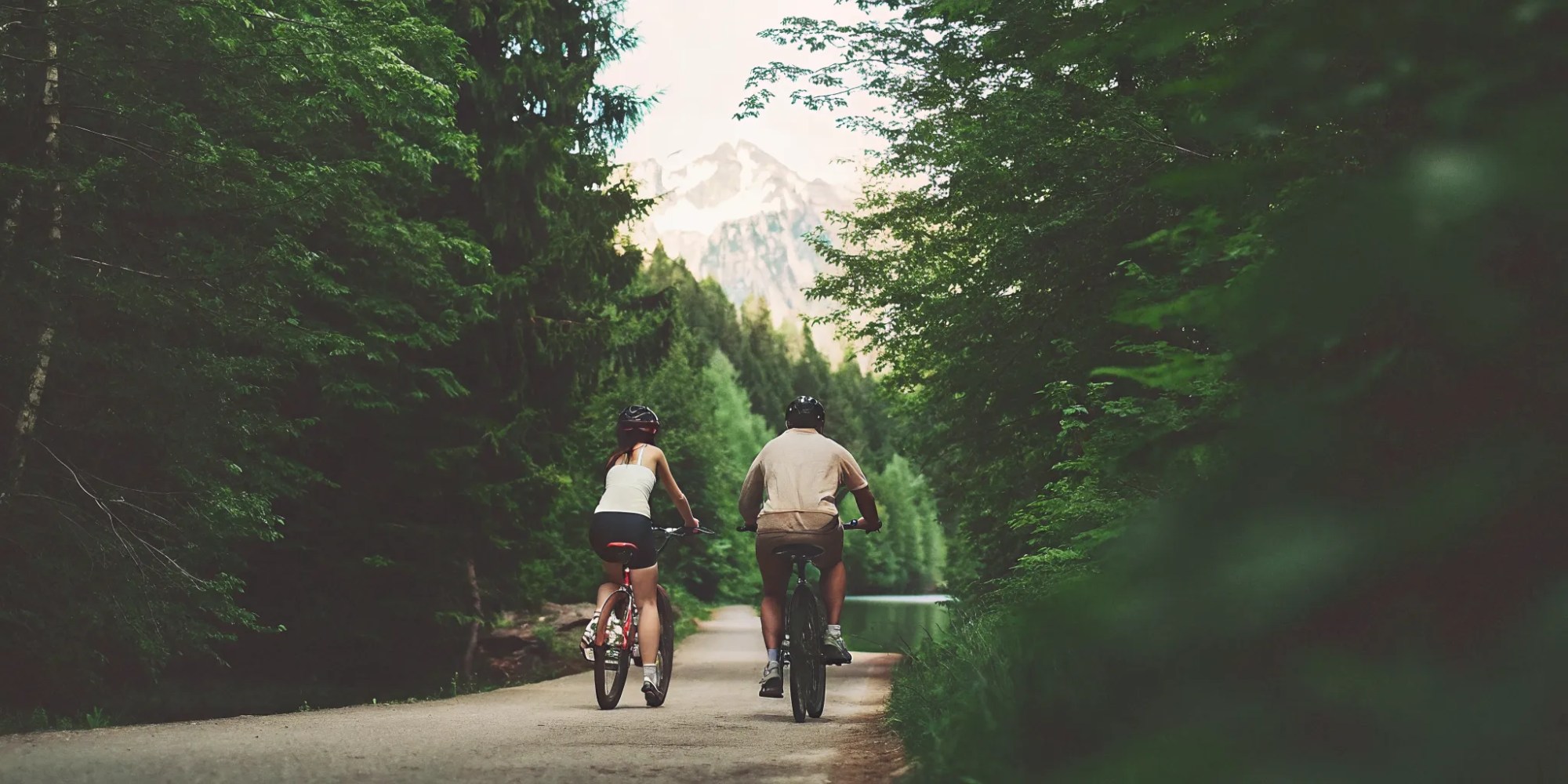 Scenic view of the Whistler Valley Trail with a glacier-fed alpine lake and mountains in the background